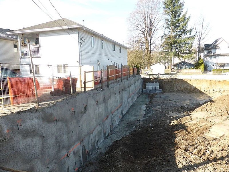 A concrete wall is being built in the yard.