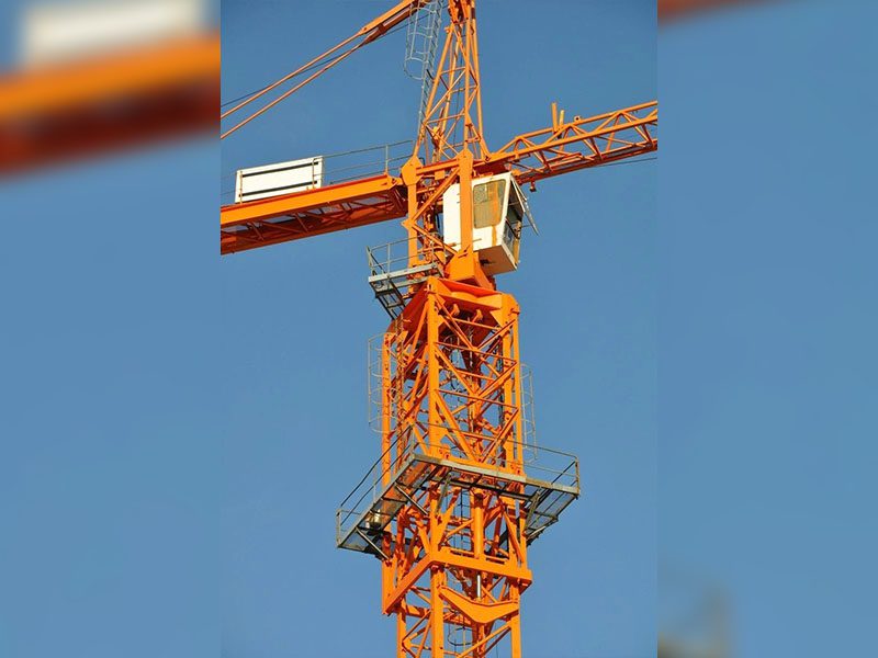 A crane is shown with the sky in the background.