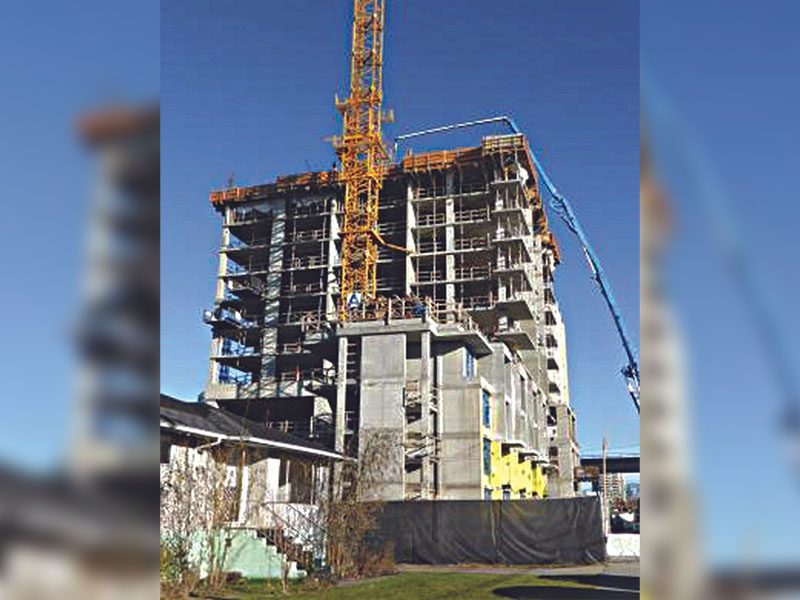 A crane is in front of the building.