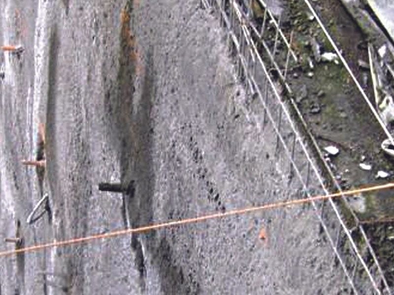 A close up of the side of a road with wires