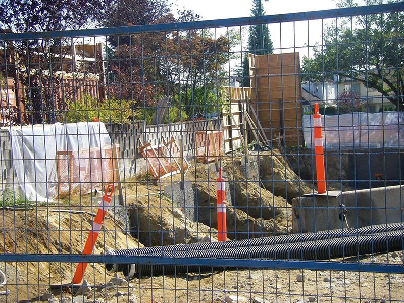A fence with orange and white poles around it