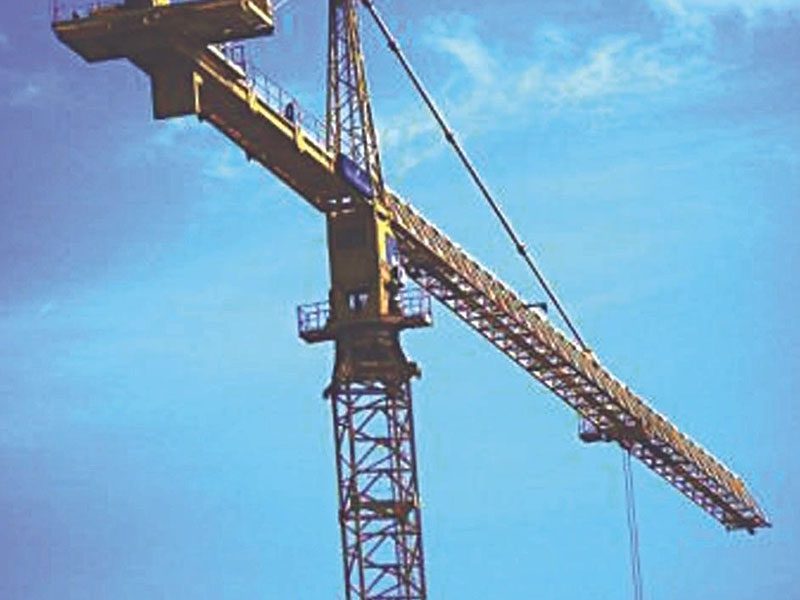 A crane is shown against the blue sky.