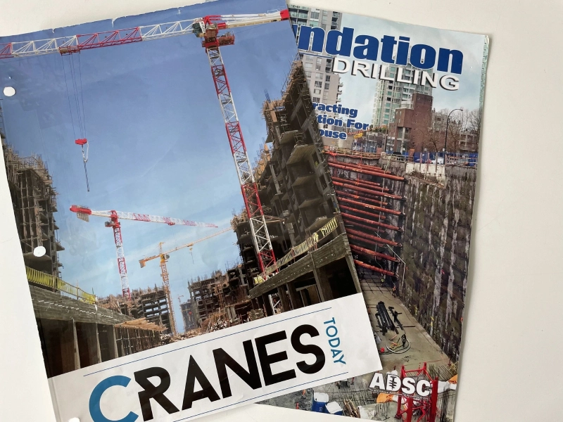 A close up of two magazines with cranes on them